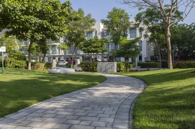 a walkway in a park with a building in the background at STAY BY LATINEM Luxury 1 BR Holiday Home OPA 1601 near Burj Khalifa in Dubai