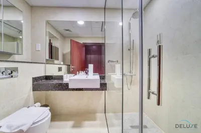 a bathroom with a shower and a toilet and a sink at Serene 1BR at Murjan 2 JBR by Deluxe Holiday Homes in Dubai