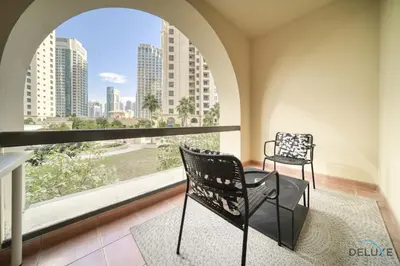 two chairs in a room with a large window at Serene 1BR at Murjan 2 JBR by Deluxe Holiday Homes in Dubai