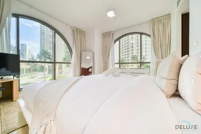 a bedroom with a large white bed with large windows at Serene 1BR at Murjan 2 JBR by Deluxe Holiday Homes in Dubai