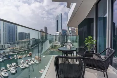 a balcony with a table and chairs and a view of a harbor at GuestReady - Modern Mirza with Marina View in Dubai