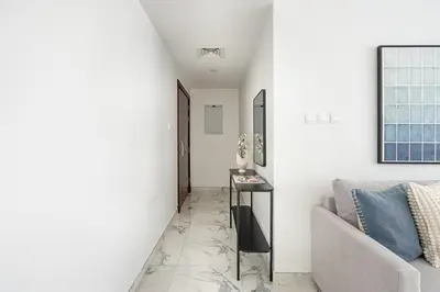 a living room with a couch and a table at Frank Porter - Opal Tower in Dubai