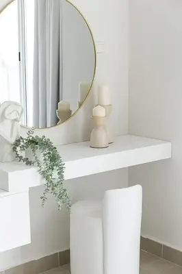 a white bathroom with a mirror and a white chair at Frank Porter - Opal Tower in Dubai