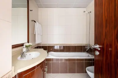 a bathroom with a bath tub and a sink at Frank Porter - Opal Tower in Dubai