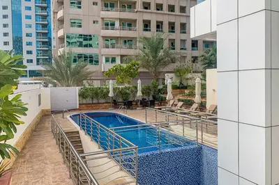 a swimming pool on the side of a building at Frank Porter - Opal Tower in Dubai
