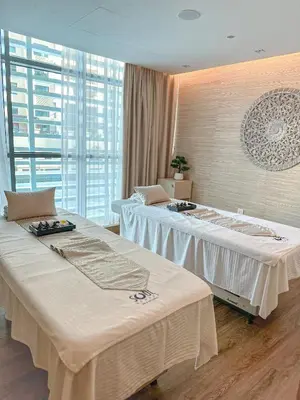 two large beds in a room with a large window at NH Collection Dubai The Palm in Dubai
