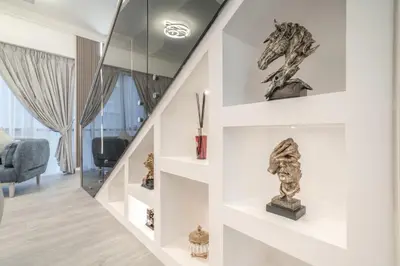a room with a staircase with a sculpture on a wall at Boutique Luxury Living near Palm Jumeirah in Dubai