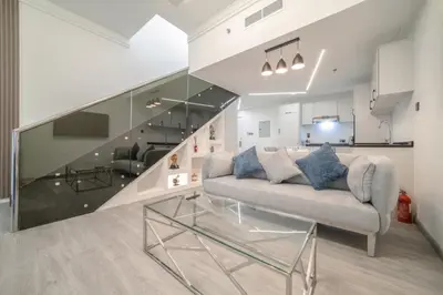 a living room with a couch and a glass table at Boutique Luxury Living near Palm Jumeirah in Dubai