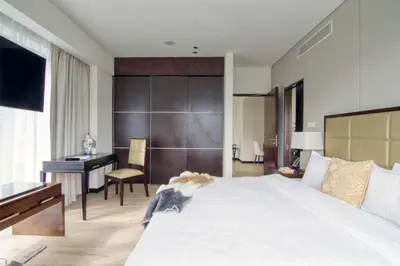 a bedroom with a large white bed and a desk at Welcome Home at The Address Marina 1BR in Dubai