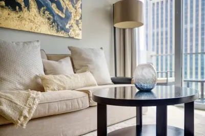 a living room with a couch and a table at Welcome Home at The Address Marina 1BR in Dubai