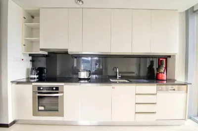 a kitchen with white cabinets and a sink at Welcome Home at The Address Marina 1BR in Dubai