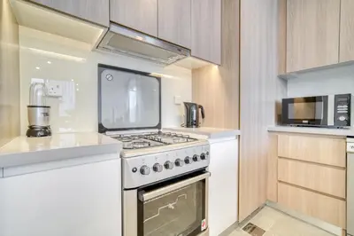 a kitchen with a stove and a microwave at Stella Maris, Dubai Marina - Mint Stay in Dubai