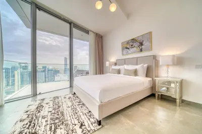 a bedroom with a white bed and a large window at Stella Maris, Dubai Marina - Mint Stay in Dubai