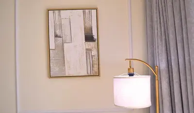 a lamp in a room with a picture on the wall at Perfect 1 Bedroom Boulevard,Fountain & Opera View in Dubai