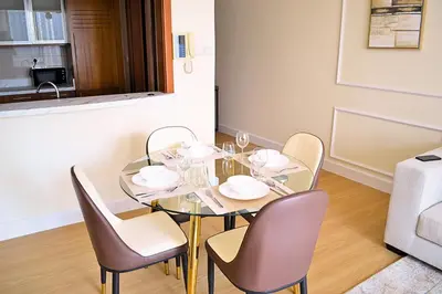 a dining room with a glass table and chairs at Perfect 1 Bedroom Boulevard,Fountain & Opera View in Dubai