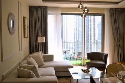 a living room with a couch and a table at Perfect 1 Bedroom Boulevard,Fountain & Opera View in Dubai