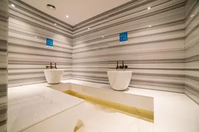 two white sinks in a room with a wall at Vacay Lettings - Waterfront Studio with great Dubai Canal view in Dubai