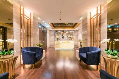 a lobby of a hotel with blue chairs and tables at Vacay Lettings - Waterfront Studio with great Dubai Canal view in Dubai
