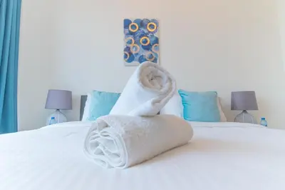 a pile of towels sitting on top of a bed at Holidays R Us Royal View in Dubai