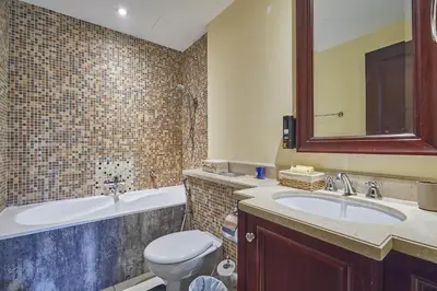 a bathroom with a sink and a toilet and a tub at Golden homes Burj khalifa view Yansoon 1BR heart & Soul old town Beside Dubai mall Burjh Khalifa in Dubai