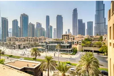 a view of a city with tall buildings and palm trees at Golden homes Burj khalifa view Yansoon 1BR heart & Soul old town Beside Dubai mall Burjh Khalifa in Dubai