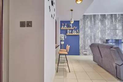 a living room with blue walls and a blue couch at Golden homes Burj khalifa view Yansoon 1BR heart & Soul old town Beside Dubai mall Burjh Khalifa in Dubai