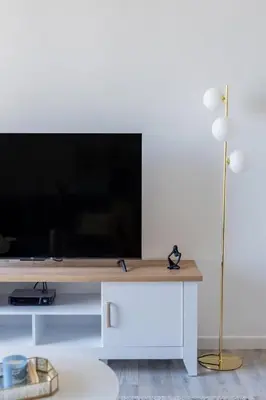 a living room with a flat screen tv on a table at GuestReady - Lux Aeterna in JBR in Dubai