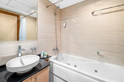 a bathroom with a white tub and a sink at Breathtaking sea-view condo in Dubai Marina - Palm Views! in Dubai