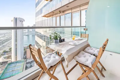 a dining room with a table and chairs and a large window at Breathtaking sea-view condo in Dubai Marina - Palm Views! in Dubai