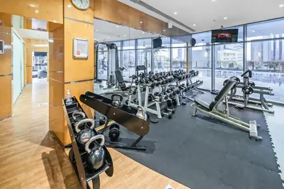 a gym with a row of treadmills and machines at Breathtaking sea-view condo in Dubai Marina - Palm Views! in Dubai
