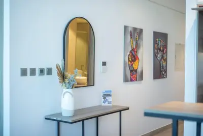 a room with two tables and a mirror on a wall at Funky STUDIO Dubai Marina outstanding facilities in Dubai