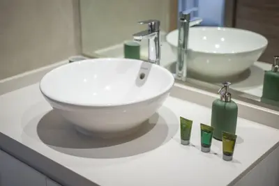 a bathroom with a white sink and a bowl at Funky STUDIO Dubai Marina outstanding facilities in Dubai