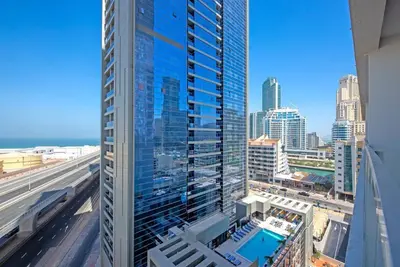 a view of a tall building with a swimming pool at Funky STUDIO Dubai Marina outstanding facilities in Dubai