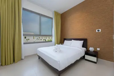 a bedroom with a large bed and a large window at Stunning 4 bedroom townhouse in Townsquare in Dubai