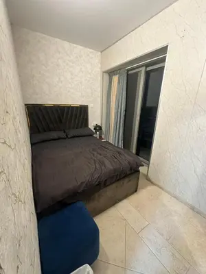 a bedroom with a bed and a blue chair at Fabulous Palm View in Dubai