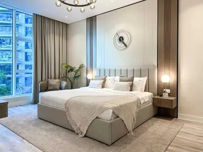 a bedroom with a large bed and a large window at Sunset view apartment in Oceana in Dubai