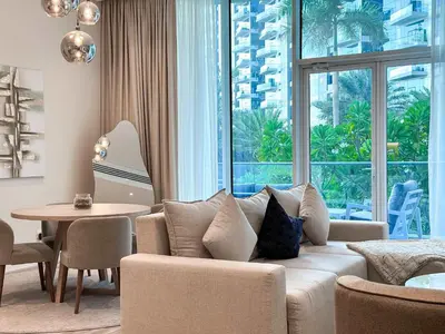 a living room with a couch and a table at Sunset view apartment in Oceana in Dubai