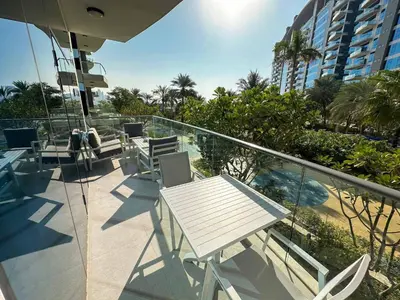 a balcony with a table and chairs on a building at Sunset view apartment in Oceana in Dubai