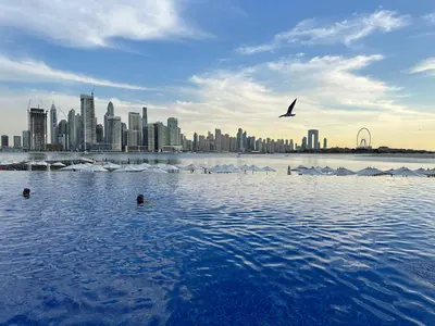 a large body of water with a city in the background at Sunset view apartment in Oceana in Dubai
