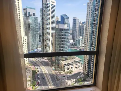 a view of a city from a window in a building at USMANS 5 BEDROOM APARTMENT at JBR WALK RIMAL ON THE BEACH 2750 SFT HUGE Direct Beach Access Fully Serviced JBR in Dubai