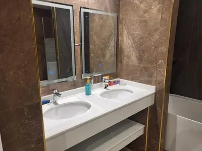 a bathroom with two sinks and two mirrors at USMANS 5 BEDROOM APARTMENT at JBR WALK RIMAL ON THE BEACH 2750 SFT HUGE Direct Beach Access Fully Serviced JBR in Dubai