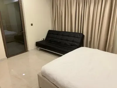 a bedroom with a bed and a black leather couch at USMANS 5 BEDROOM APARTMENT at JBR WALK RIMAL ON THE BEACH 2750 SFT HUGE Direct Beach Access Fully Serviced JBR in Dubai