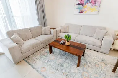 a living room with a couch and a coffee table at Modern 1BR in Dubai Marina Near Metro & Beach in Dubai