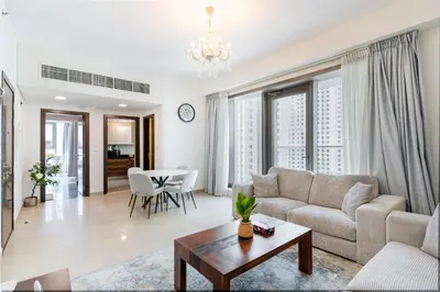 a living room with a couch and a table at Modern 1BR in Dubai Marina Near Metro & Beach in Dubai