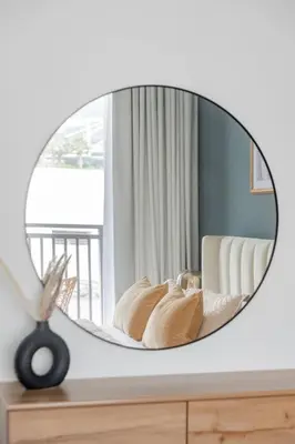 a mirror on top of a table with a bed at GuestReady - Contemporary with Ain Dubai View in Dubai