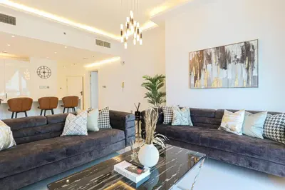 a living room with a large couch and a table at HiGuests - Luxurious High-Rise Apartment With Stunning Views in Dubai