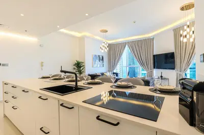 a kitchen with a sink and a stove top oven at HiGuests - Luxurious High-Rise Apartment With Stunning Views in Dubai