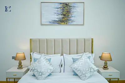 a bedroom with a bed with two night stands and two lamps at Luxury Escapes - Palm Jumeirah's Spectacular Ocean-View Apartment - NABAT in Dubai