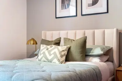 a bedroom with a bed with pillows on it at GuestReady - Sea la Vie - Lux in JBR in Dubai
