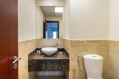 a bathroom with a sink and a toilet and a mirror at GuestReady - Sea la Vie - Lux in JBR in Dubai